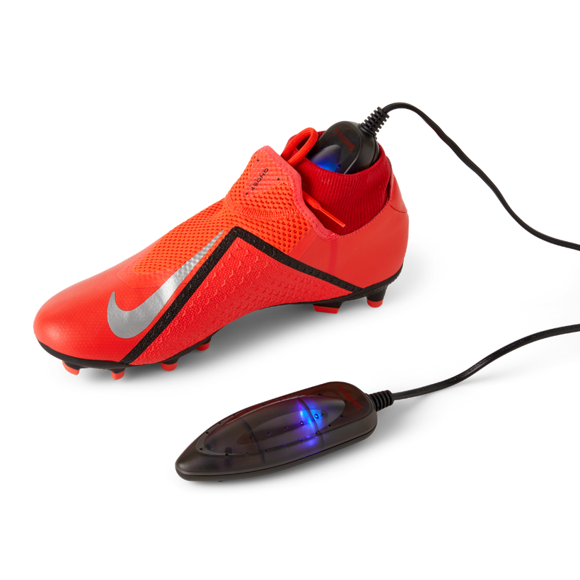 ShoeDry Airo Travel portable shoe dryer in a football boot